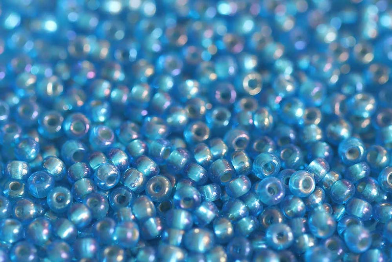 Preciosa Rocailles 10/0 Transparent Dark Aqua Silver Lined Rainbow col.67159