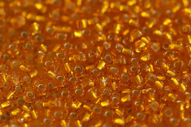 Preciosa Rocailles 10/0 Transparent Light Orange Silver Lined col.87060