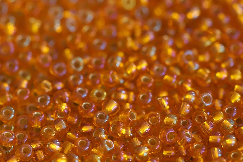 Preciosa Rocailles 10/0 Transparent Light Orange Silver Lined Rainbow col.87069