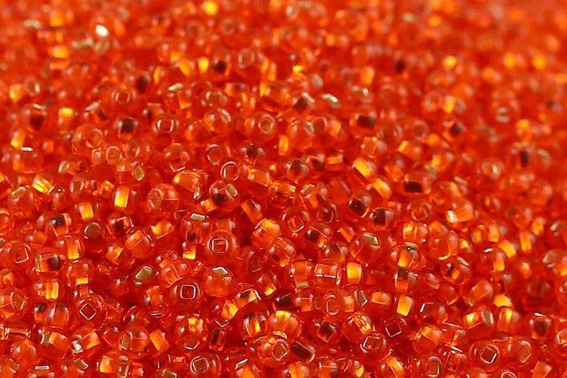 Preciosa Rocailles 11/0 Transparent Dark Orange Silver Lined col.97030
